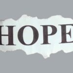 A torn paper with the word hope written on it.