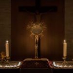 A cross and candles in front of the altar.