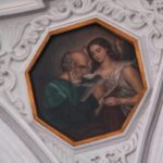 A painting of an old man and woman in a white frame.