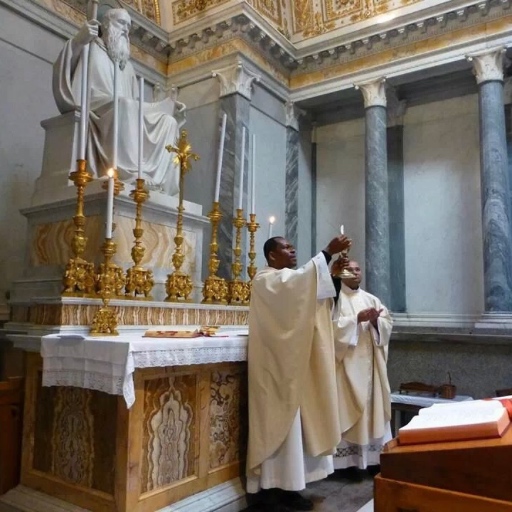 Two men in white robes standing at a alter.