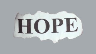 A torn paper with the word hope written on it.